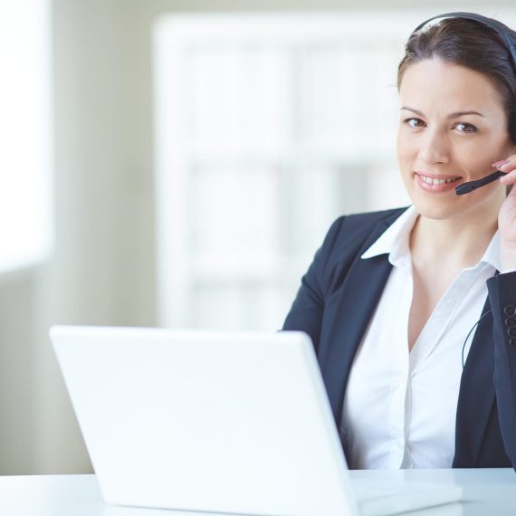 Young customer support representative looking at camera with smile